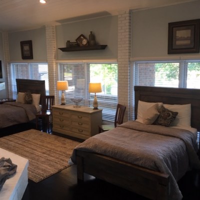 a living room with a bed and a large window