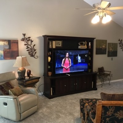a living room filled with furniture and a flat screen tv