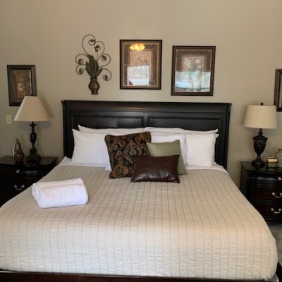 a bedroom with a bed and desk in a room