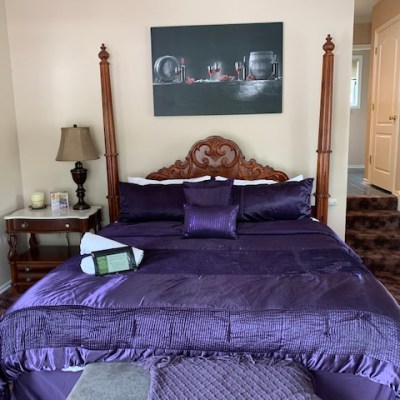 a bedroom with a bed and a chair in a room