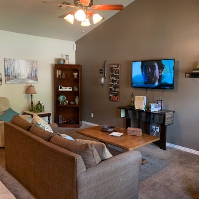 a living room filled with furniture and a flat screen television