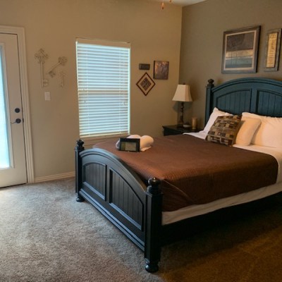 a bedroom with a bed and desk in a room